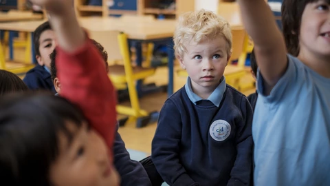 young student looking at the teacher