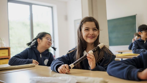 student with a flute in music class