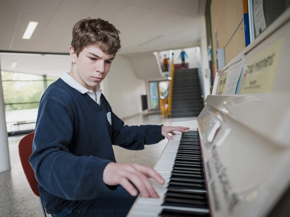 student playing the piano