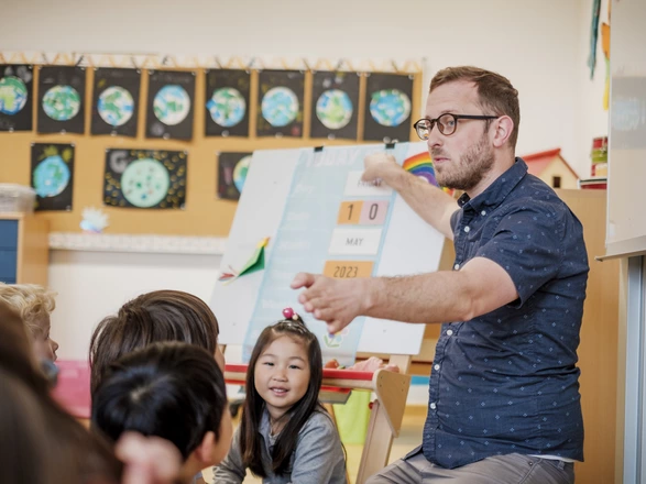 Teacher in class with young students