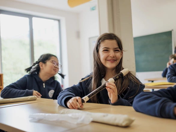 student with a flute in music class
