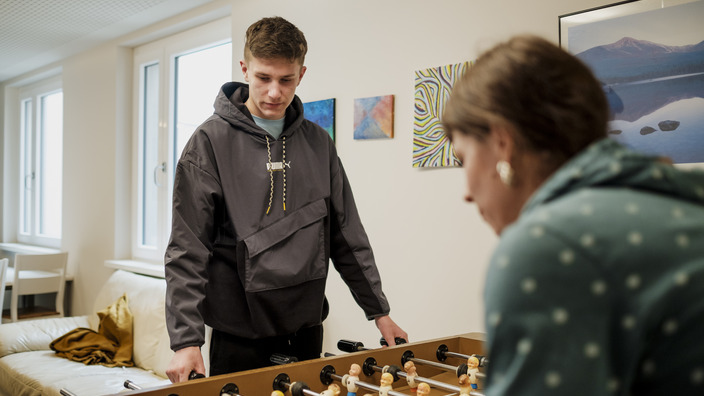 Student playing table football