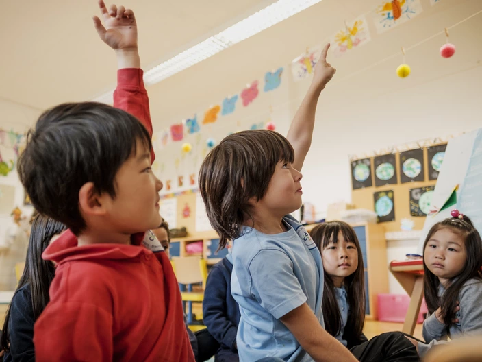 Students raise their hands to say something