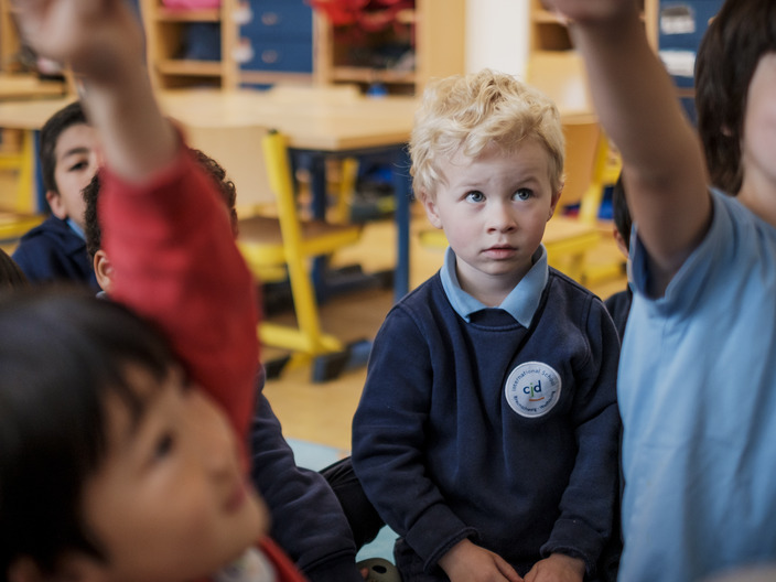 young student looking at the teacher