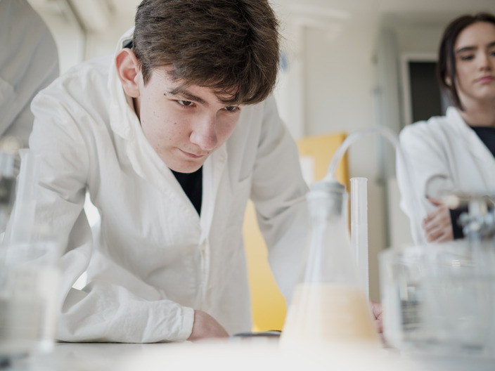 Student looking at a chemical experiment